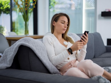 person sitting on couch while wearing radius t and masimo w1 