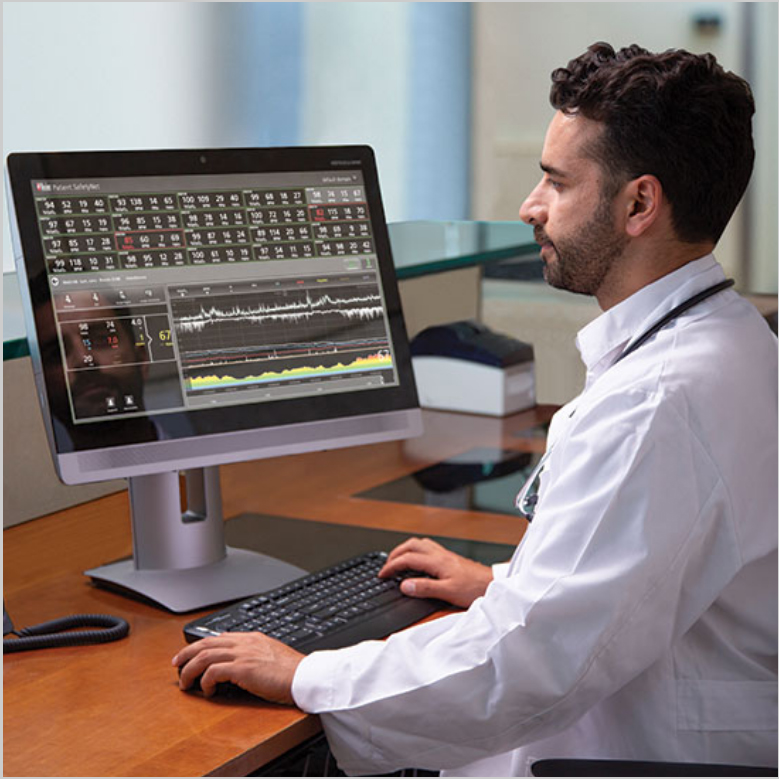 Clinician reviewing information on a computer running Masimo software.